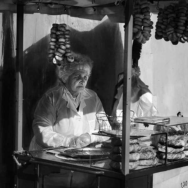 An old woman working in a market stall