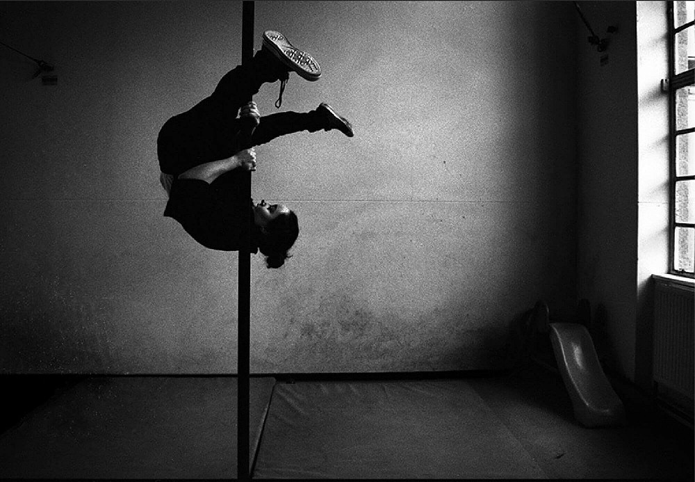 Woman pole dancing in a studio